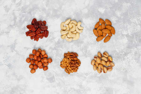 Assortment of nuts Cashew, hazelnuts, walnuts, pistachio, pecans, pine nuts, peanut, raisins.top viewの写真素材