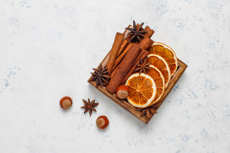 Mulled wine spices in wooden box on light background