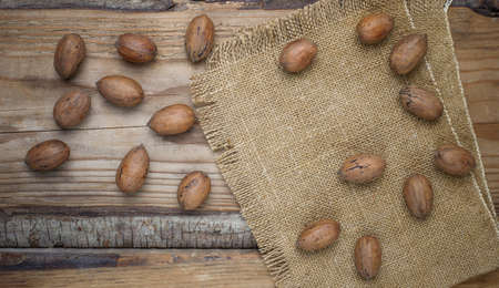 Pecan nuts on rustic background,top view
