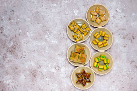 Traditional oriental sweets with different nuts on concrete background, top view, copy spaceの写真素材