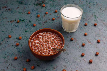 Bowl with chocolate balls and milk on light background,top viewの写真素材