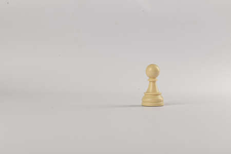 White single pawn figure isolated on white backgroundの写真素材