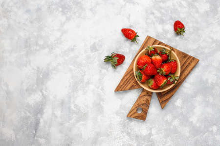 Fresh organic berries on grey concrete background,top view,copy space