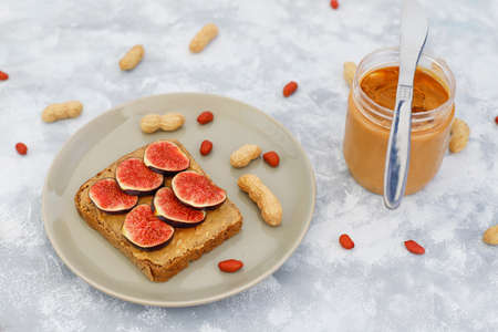 Traditional American and European summer breakfast: sandwiches of toast with peanut butter, berry,peach,fig, strawberry,raspberry, copy space top viewの写真素材