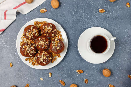 Chocolate-walnut muffins with coffee cup with walnuts on dark background ,Selective Focus.