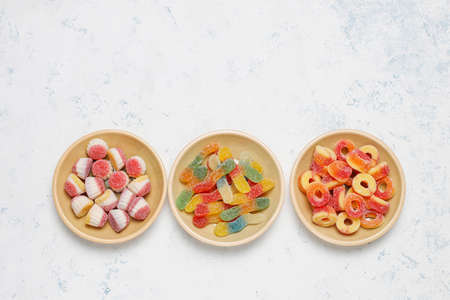 Colorful candies, jelly,marshmallow on light background. Top view with copy spaceの写真素材