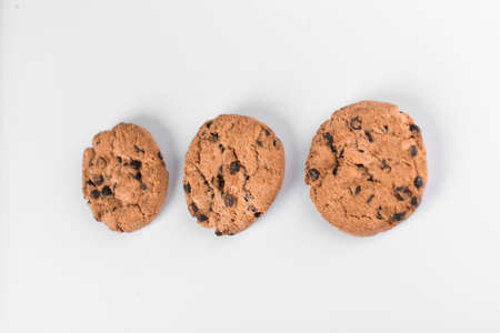 Oatmeal cookies with chocolate chips on whiteの写真素材