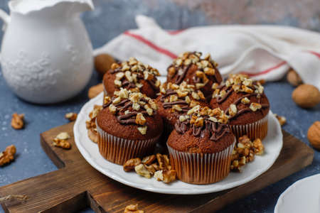 Chocolate-walnut muffins with coffee cup with walnuts on dark background ,Selective Focus.の写真素材