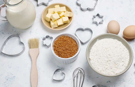 Ingredients for baking - milk,butter,eggs, flour wheat,brown sugar,cookie cutters white...