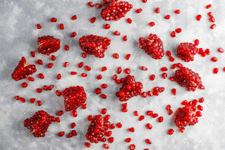 Sweet pomegranate seeds on concrete background,selective focusの写真素材