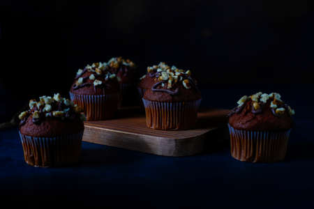 Chocolate-walnut muffins with coffee cup with walnuts on dark background ,Selective Focus.の写真素材