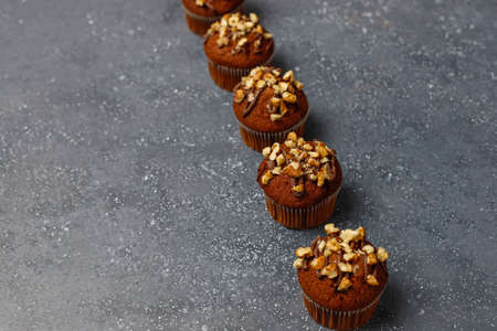 Chocolate-walnut muffins with coffee cup with walnuts on dark background ,Selective Focus.