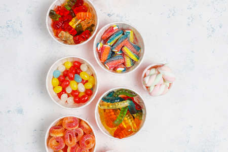 Colorful candies, jelly,marshmallow on light background. Top view with copy spaceの写真素材