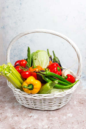 Different colorful fresh vegetables on light concrete background,healthy foodの写真素材