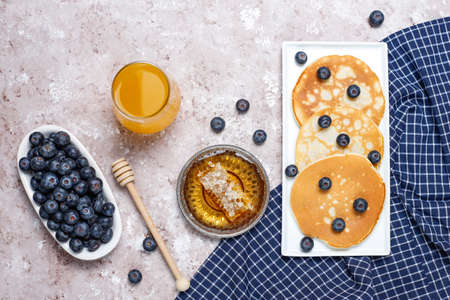 blueberry pancakes on brown light background,top viewの写真素材