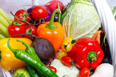 Different colorful fresh vegetables on light concrete background,healthy foodの写真素材