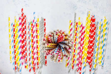 Paper straws of different colors on light background with copy spaceの写真素材