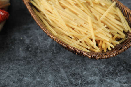 Homemade fresh spaghetti in the basket platterの写真素材