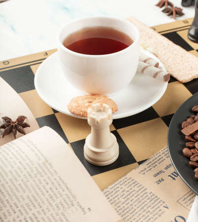 A cup of tea and a chess rookの写真素材