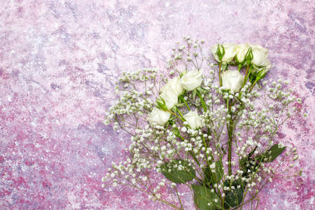 March 8 Womens Day card with white flowers,sweets and a cup of tea on light background.