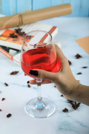 Holding the glass of red rose wine in the hand of a womanの写真素材