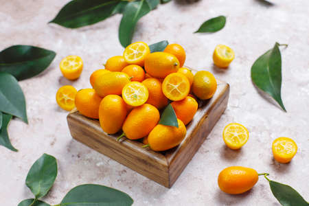Flat lay of kumquats on a concrete background. Top view