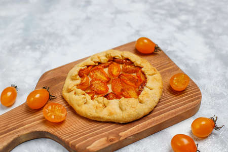 Homemade yellow cherry galette pie on grey light background,top view,space for copy or textの写真素材