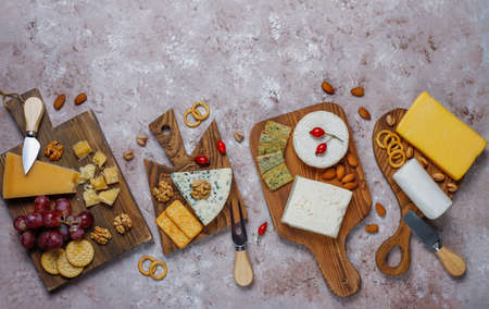 Various types of cheese on light brown background,top viewの写真素材