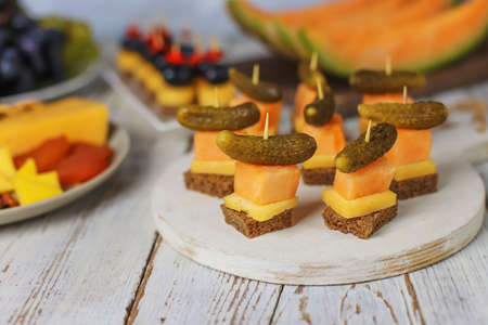 Assortment of canapes on white table.