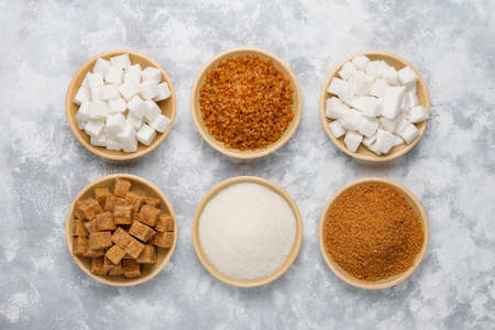 Various types of sugar, brown sugar and white on concrete background,top viewの写真素材