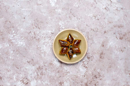 Traditional oriental sweets with different nuts on concrete background, top view, copy spaceの写真素材