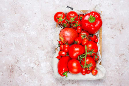 Fresh red vegetables on light concrete background,top viewの写真素材