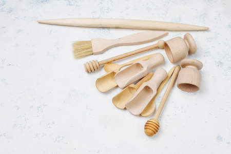 Set of wooden kitchen utensils on concrete background,top view