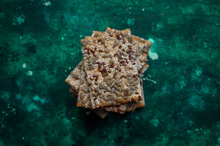 Assortment of salt crackers shot from the top on colorful background with copy space. Salty party...