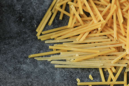 Homemade fresh spaghetti on the right side of the background