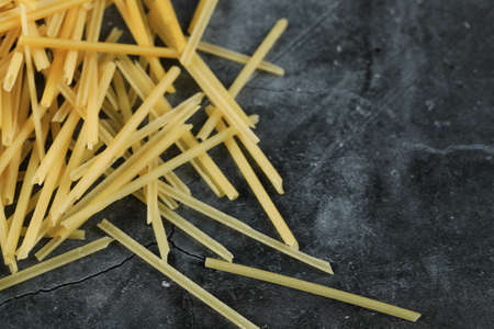 Homemade fresh spaghetti on the top corner side of the backgroundの写真素材