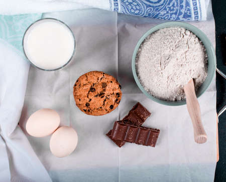 Cookies, chocolate, eggs, milk and flour. Top view