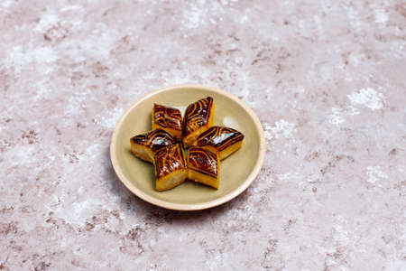 Traditional oriental sweets with different nuts on concrete background, top view, copy space
