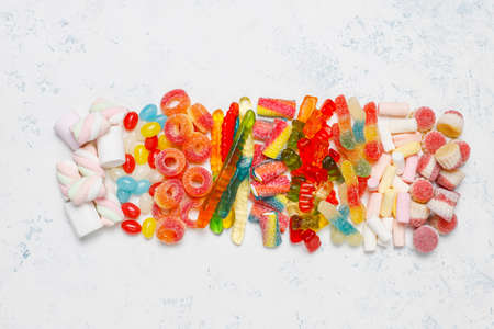 Colorful candies, jelly,marshmallow on light background. Top view with copy spaceの写真素材