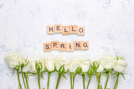 Spring card with white roses and flowers on light background,top viewの写真素材