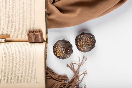 Chocolate pralines on white table. top view