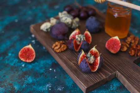 black figs with blue cheese and honey,nutsの写真素材