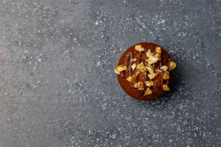 Chocolate-walnut muffins with coffee cup with walnuts on dark background ,Selective Focus.の写真素材