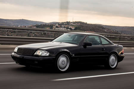 Black sedan car high speed drive on the highway