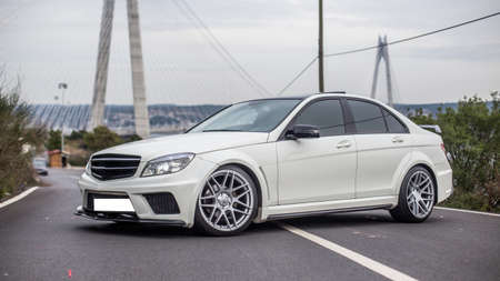White business class sedan parking in the middle of the roadの写真素材