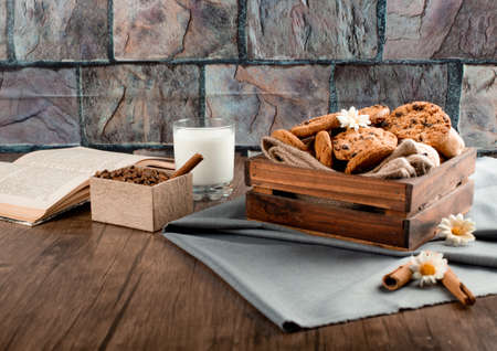 Cookies in a wooden tray with a glass of milk