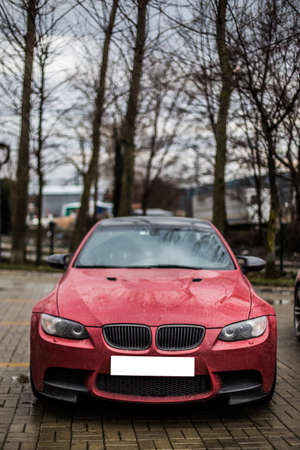 Red sport car parking in the streetの写真素材