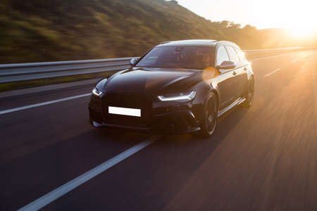 Black business class sedan in the sunset