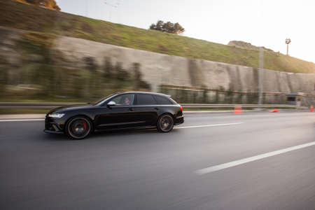 Black hatchback driving in the tunnelの写真素材