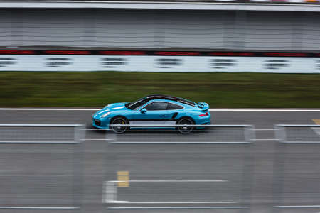 Blue racing sport car on the trace in the stadium